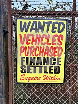 Ã¢â¬ËVehicles Purchased, Finance SettledÃ¢â¬â¢ Signage at a Used Car Forecourt photo